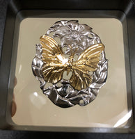 Authorized reproduction of an original museum quality Rainforest Design®️handcrafted shell cameo, carved in Panama by a master Wounaan Indian artist. Part of the proceeds go to the artist whose signature appears on the reverse.   Blue  Morpho butterflies are commonly seen From your car by visitors to the Panama rainforest. Their iridescent blue color is unmistakeable and unforgettable. 