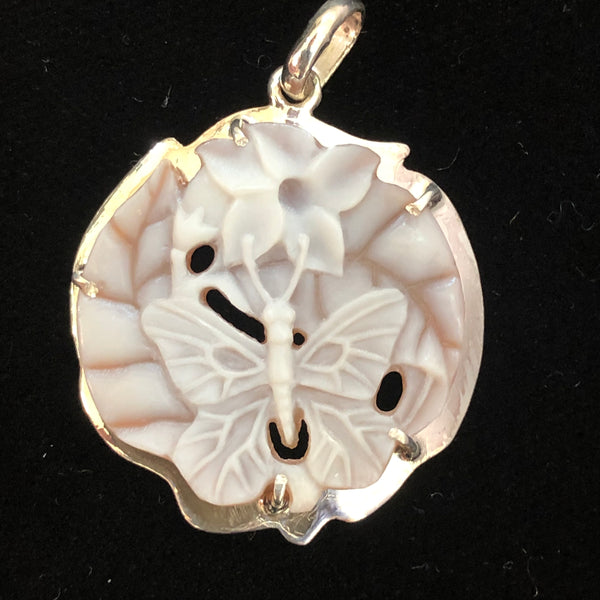 Blue butterfly w/flower 24mm shell camel pendant, handcrafted in our latticework style and set in 950 silver. Registry number #2913, this is a unique, one of a kind carved piece. Artist signed on the reverse. Hallmark on reverse. Comes with an 18” rhodium plated sterling silver chain. Sold with a Certificate of Authenticity, eso- friendly, fair trade. 