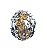 Seahorse w/grass pendant, 30mm, rhodium plated, .925 sterling silver, 18Kt gold plating highlighting this adorable seahorse. Sold with an 18” rhodium plated, sterling silver chain.  Authorized reproduction of an original museum quality Rainforest Design®️handcrafted shell cameo, carved in Panama by a master Wounaan Indian artist. Part of the proceeds go to the artist whose signature appears on the reverse.   Shipped in suspension frame box with gift ready cover. 