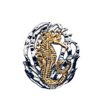 Seahorse w/grass pendant, 30mm, rhodium plated, .925 sterling silver, 18Kt gold plating highlighting this adorable seahorse. Sold with an 18” rhodium plated, sterling silver chain.  Authorized reproduction of an original museum quality Rainforest Design®️handcrafted shell cameo, carved in Panama by a master Wounaan Indian artist. Part of the proceeds go to the artist whose signature appears on the reverse.   Shipped in suspension frame box with gift ready cover. 