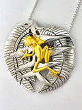 Frog on halyconia pendant, 25mm, .925 silver, 18kt gold plated, sold with 18” rhodium plated, sterling silver chain.   Authorized reproduction of an original museum quality Rainforest Design®️handcrafted shell cameo, carved in Panama by a master Wounaan Indian artist. Part of the proceeds go to the artist whose signature appears on the reverse.   The Panama Golden Frog or Rana Dorada, is now extinct in the wild,  and only exists in captivity in a few places where attempts to breed them are being made. 