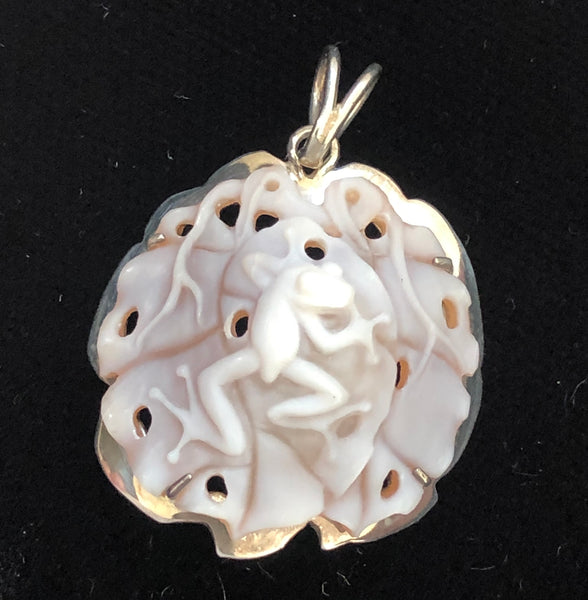 Frog on leaves w/holes, 22mm cameo pendant, handcrafted in our latticework style and set in 950 silver. Sold with an 18” rhodium plated sterling silver chain to complete the look.  Comes with a Certificate of Authenticity. This is a unique piece, registry number #2516. One-off, eco-friendly, fair trade.
